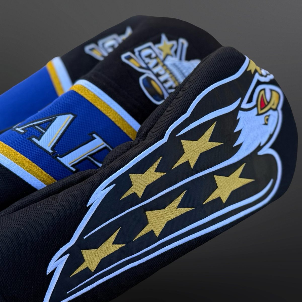 Handmade golf headcovers made from vintage hockey jerseys featuring team-inspired stripes and textures.
