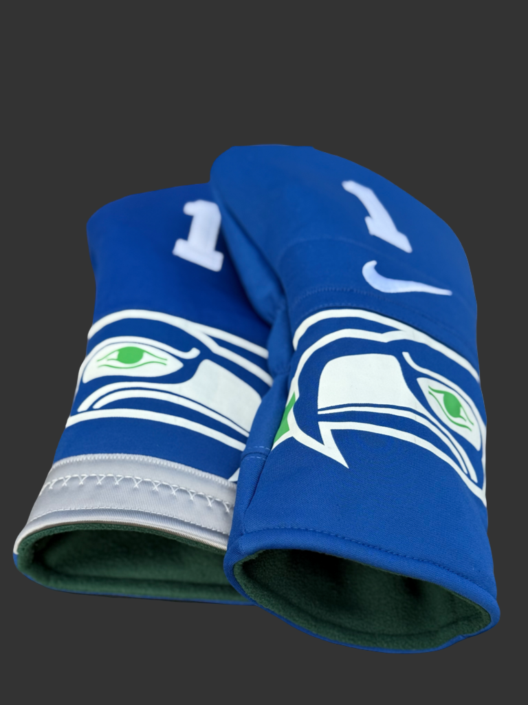 Upcycled football jersey golf headcovers in red, blue, and team-inspired colors displayed on a golf bag.