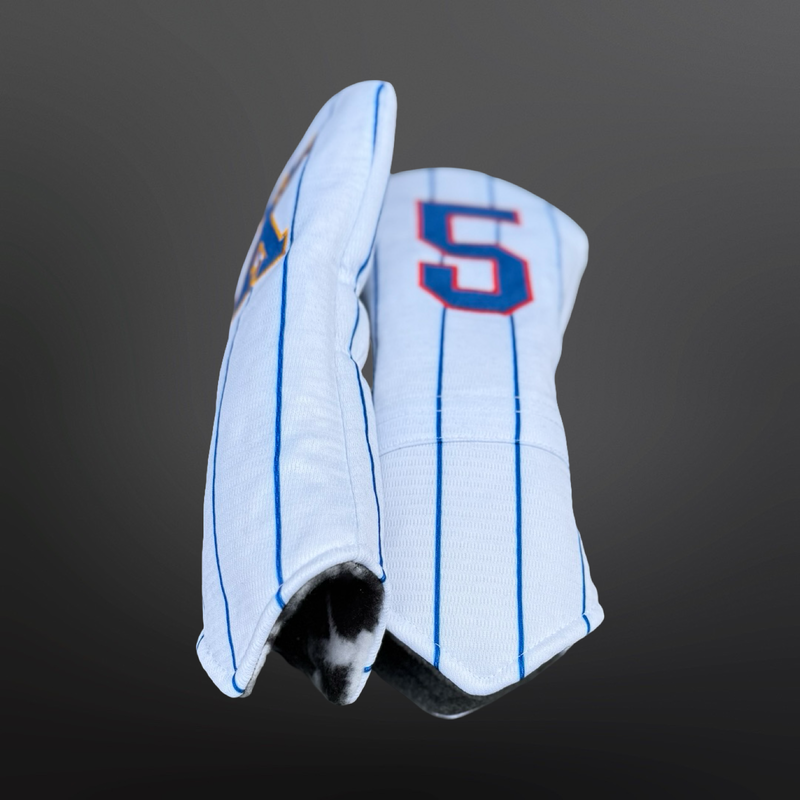 Handmade golf headcovers crafted from upcycled baseball jerseys in classic red, white, and blue tones.